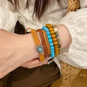 Detail of Bohemian stackable bracelet set with wood beads and turquoise accents.