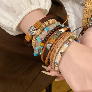 Close-up detail of bohemian multilayer beaded bracelet set with wood beads and leather