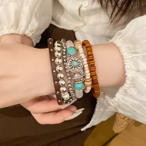 Detailed close-up of a bohemian multi-layer bracelet set with wooden beads and turquoise