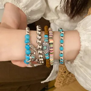 Close-up of bohemian beaded bracelet set featuring bull head charm and turquoise beads