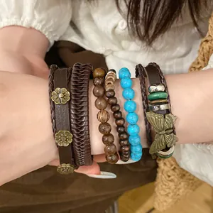 Close-up of ethnic style bracelet set featuring wood beads and butterfly charm