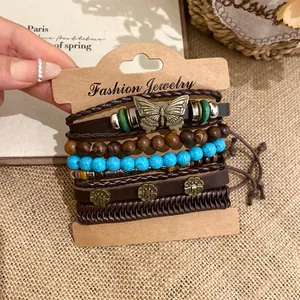Close-up of ethnic vintage bracelet set with leather, wood beads, and butterfly charm
