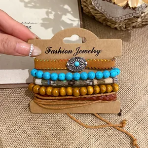 Detailed macro view of bohemian multi-layer beaded bracelet set featuring turquoise and wood.