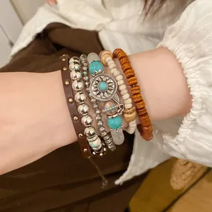 Close-up of a bohemian beaded bracelet set featuring turquoise and wooden bead accents