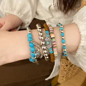 Close-up of boho multi-layer beaded bracelet set with turquoise and ox head pendant