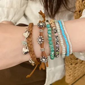 Stacked vintage ethnic beaded bracelet set featuring hearts, flowers and colorful beads.