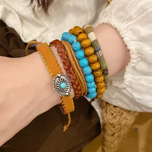 Close-up detail of bohemian multi-layer bracelet set featuring turquoise beads and wood beads