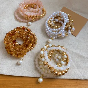 Multi-layered acrylic pearl and gold bead bracelet set in four elegant color variants.