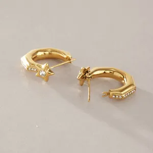 Detailed view of 18k gold-plated star hoop earrings with sparkling clear crystals