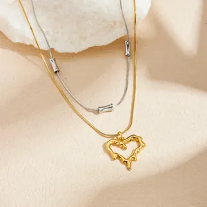 Close-up detail of a gold-plated stainless steel necklace with irregular lava heart pendant