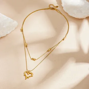 Detail of gold-plated stainless steel necklace with lava-textured irregular heart pendant