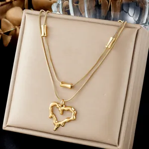 Close-up of gold-plated stainless steel necklace with irregular lava heart pendant.
