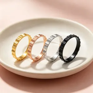 Detail view of four 3mm stainless steel gear rings in gold, rose gold, silver, and black