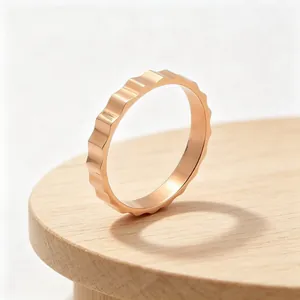 Detail view of a 3mm rose gold stainless steel ring featuring a unique sawtooth gear texture
