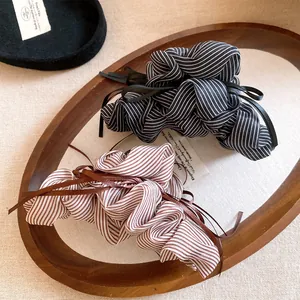 Close-up of elegant Korean style striped fabric bow hair claw clips with long ribbons