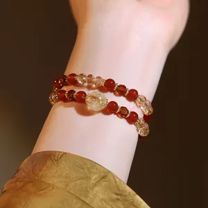 Detailed view of a double-layered beaded bracelet with red and yellow crystal stones
