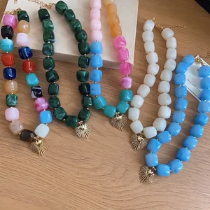 Colorful resin square beaded necklace with a golden heart sunburst charm pendant