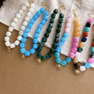Handmade colorful resin square beaded necklace with a golden heart sunburst pendant