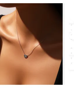 Detailopname van een zilveren gevlochten hartjesketting met moissaniet op model.