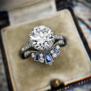 Macro view of a vintage style engagement ring set with blue and clear stones
