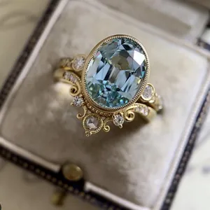 Detail shot of a vintage engagement ring set featuring an oval blue center stone