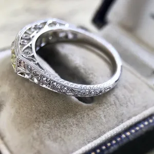 Close-up of vintage silver-plated ring featuring intricate filigree and zircon inlay