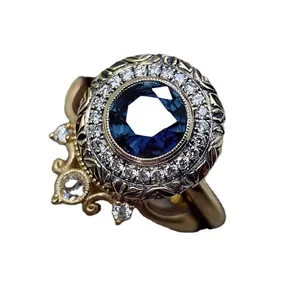 Macro detail of vintage ring featuring a deep blue center stone and intricate engraving