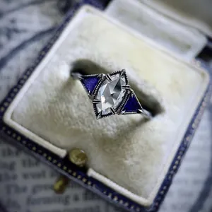 Macro view of marquise-cut zircon engagement ring in vintage box packaging