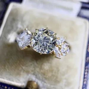 Close-up of gold engagement ring with large CZ stones in vintage jewelry box