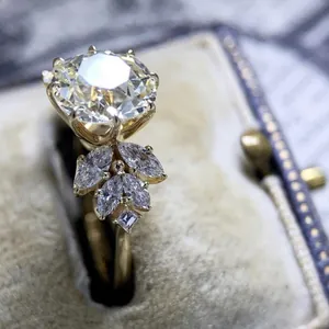 Macro view of gold engagement ring with large zircon and marquise stones leaf design