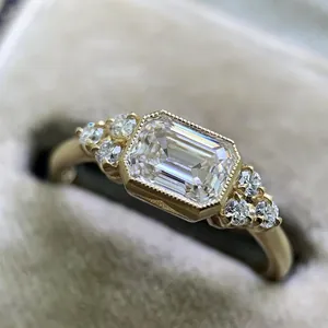 Detailed close-up showing the facets of an emerald-cut zircon set in a gold bezel ring