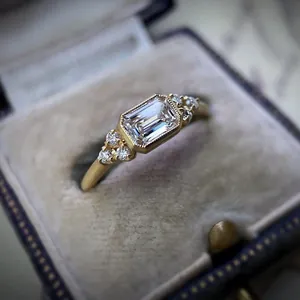 Detailed view of antique style emerald-cut zirconia engagement ring in a luxury velvet box