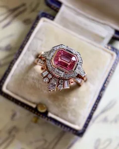 Macro view of vintage rose gold engagement ring with pink emerald-cut zircon