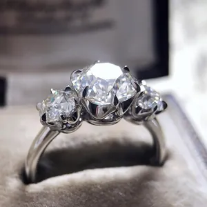 Detailed macro shot of a shiny silver three-stone cubic zirconia engagement ring.