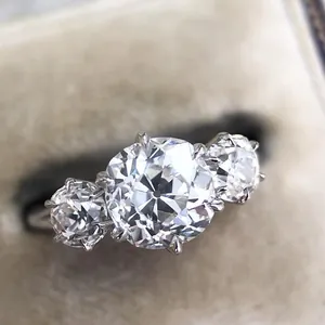 Macro view of a stunning three-stone engagement ring with sparkling round cubic zirconia.