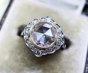 Vintage rose cut zircon engagement ring with floral halo and two-tone alloy finish.