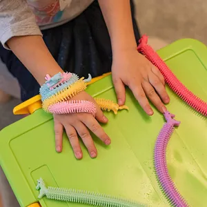 Detailed shot of colorful unicorn stretchy fidget bracelets worn on a child's wrist