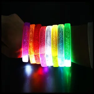 Close-up macro view of colorful glowing LED acrylic bracelets on wrist for night parties