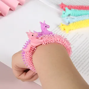 Close-up detail of a pink unicorn TPR soft glue stress relief bracelet worn on the wrist