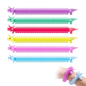 Set of six colorful triceratops-shaped stretchy fidget bracelets for sensory stress relief