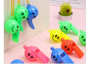 Close-up of colorful smile face plastic whistles with lanyards for cheerleading.