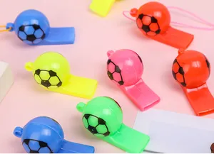 Close-up of colorful football-shaped whistles with lanyards on a soft pink background