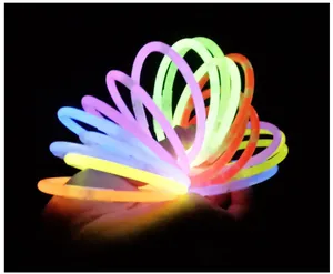 Assorted colorful glow stick bracelets glowing vibrantly in dark for party fun