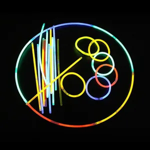 Multi-colored neon glow sticks and bracelets set against a black background for parties