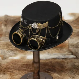 Close-up of steampunk top hat with gold goggles, gears, and wings on wooden stand