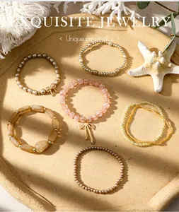 Close-up detail of Bohemian style stackable bead bracelet set with bow charms