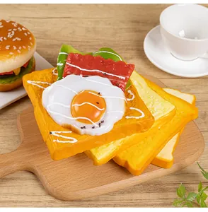Close-up of highly realistic PU foam sandwich food model with fried egg and bacon topping