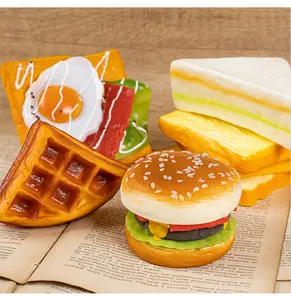 Realistic PU food models including a hamburger and waffle on an open book prop.