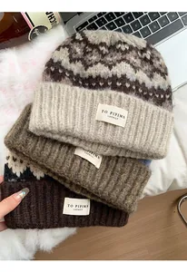 Detailed view of three vintage knit beanies in earthy tones with soft wool texture