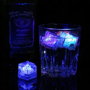 Multicolor LED glowing ice cubes for drinks in a bar setting atmosphere